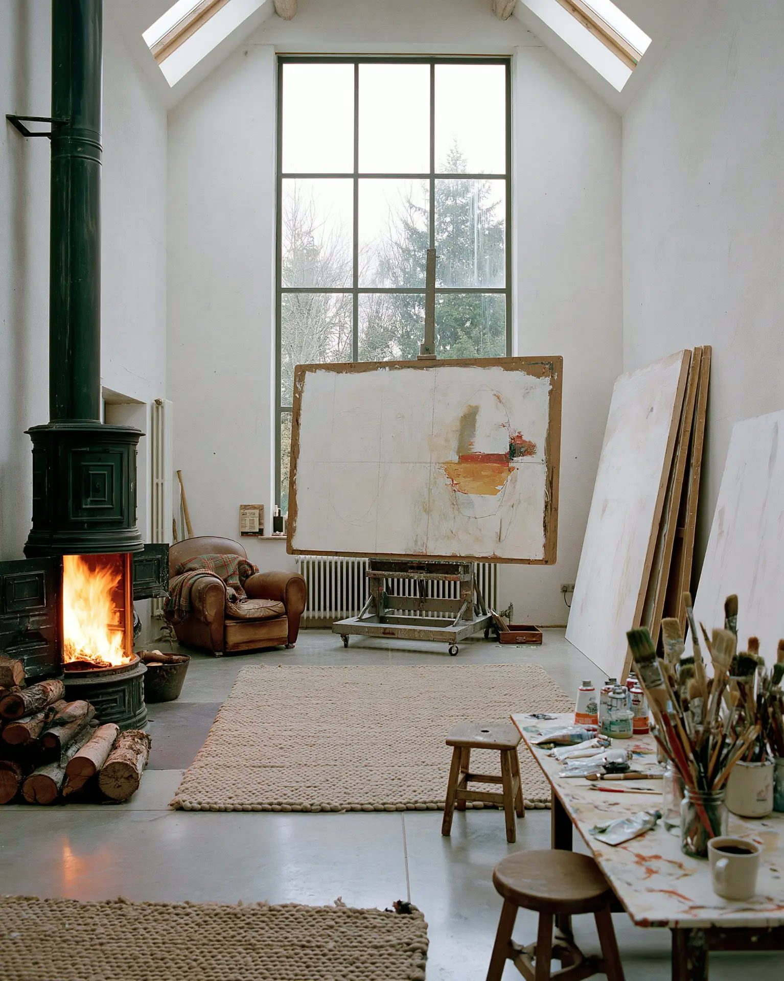 Artist's studio with a large canvas and a stove