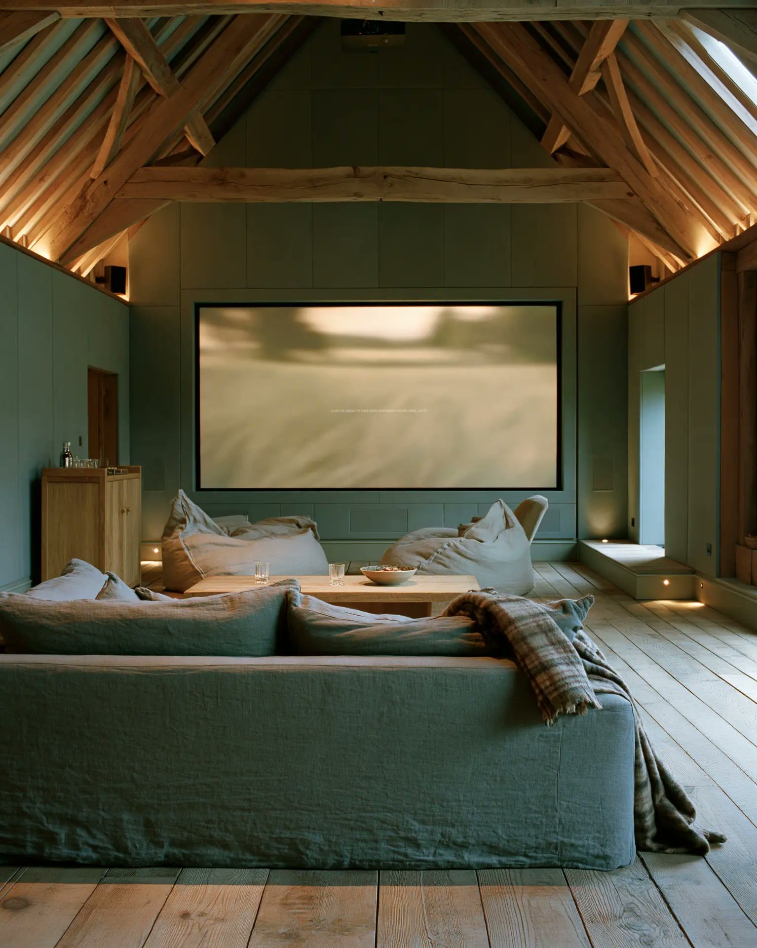 Cinema room with a large sofa facing the screen