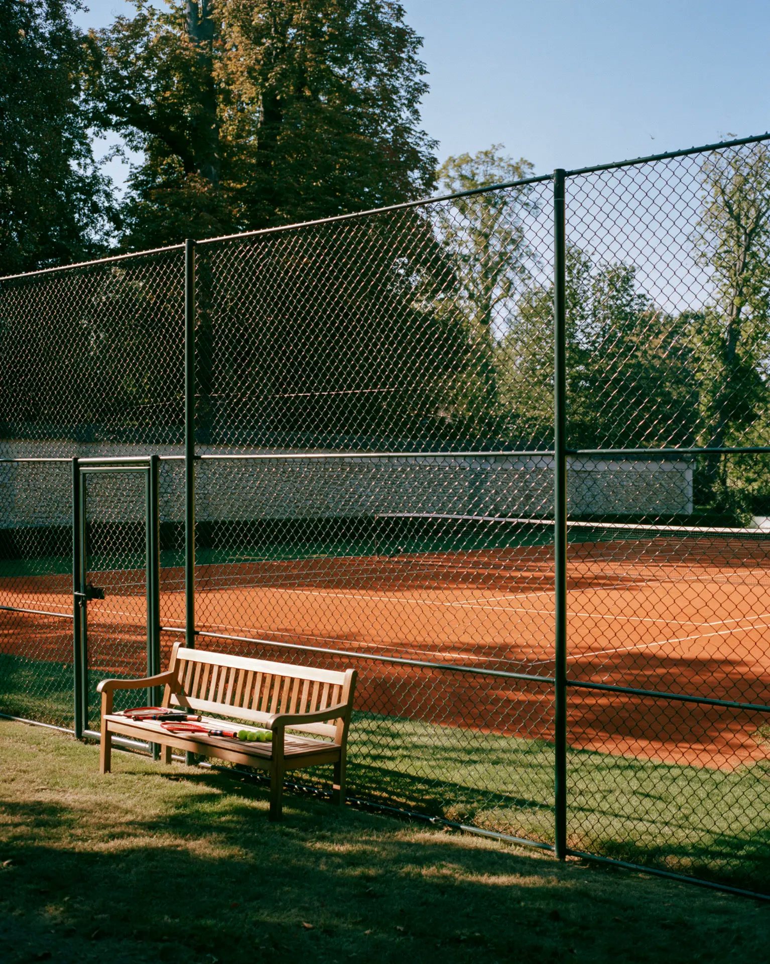 Fenced clay tennis court
