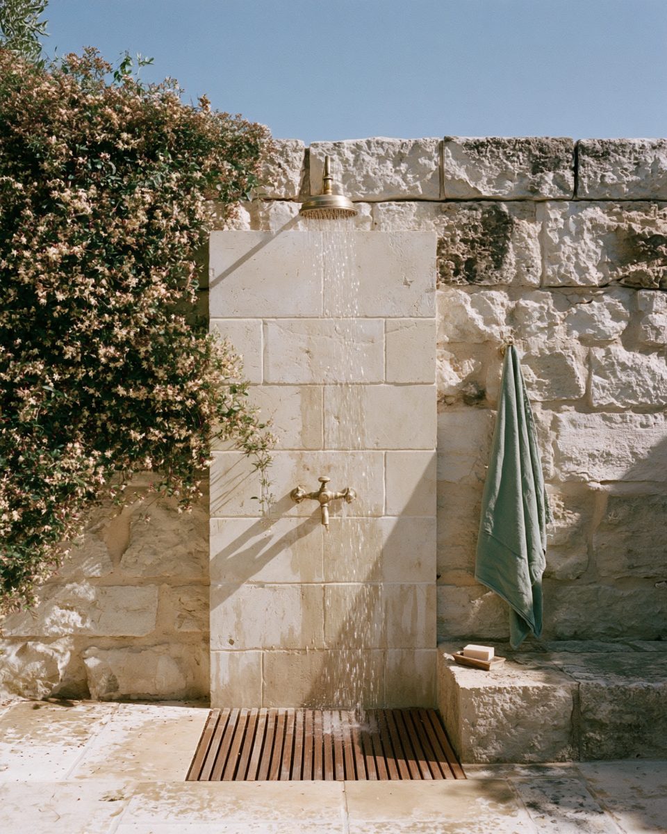 Outdoor stone shower with brass fittings