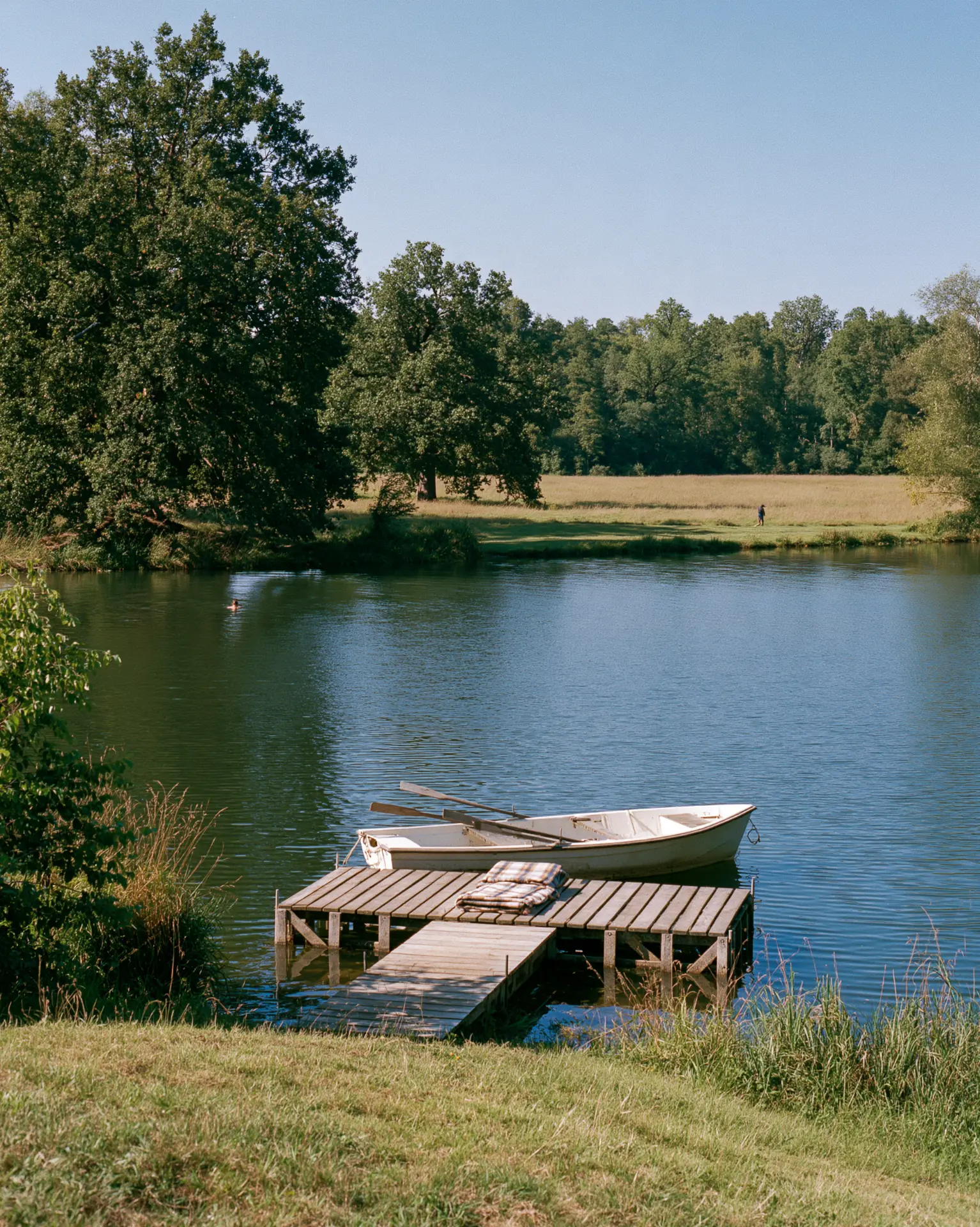 Bathing lake with pontoon and rowing boat